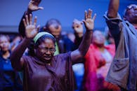 People gathered in a heartfelt prayer meeting, expressing unity and devotion.